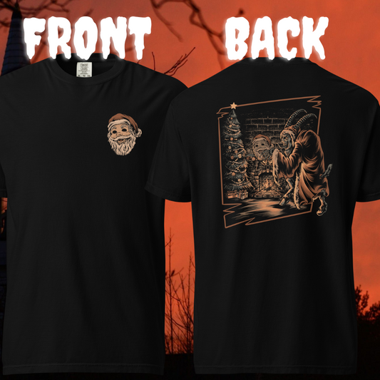 Black T-shirt featuring a small front chest print of a Santa mask and a large back graphic of Krampus holding the Santa mask in front of a decorated Christmas tree against a brick wall.