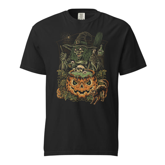 A black t-shirt with a graphic print of a witch and a pumpkin cauldron surrounded by spooky elements like skulls and a black cat.