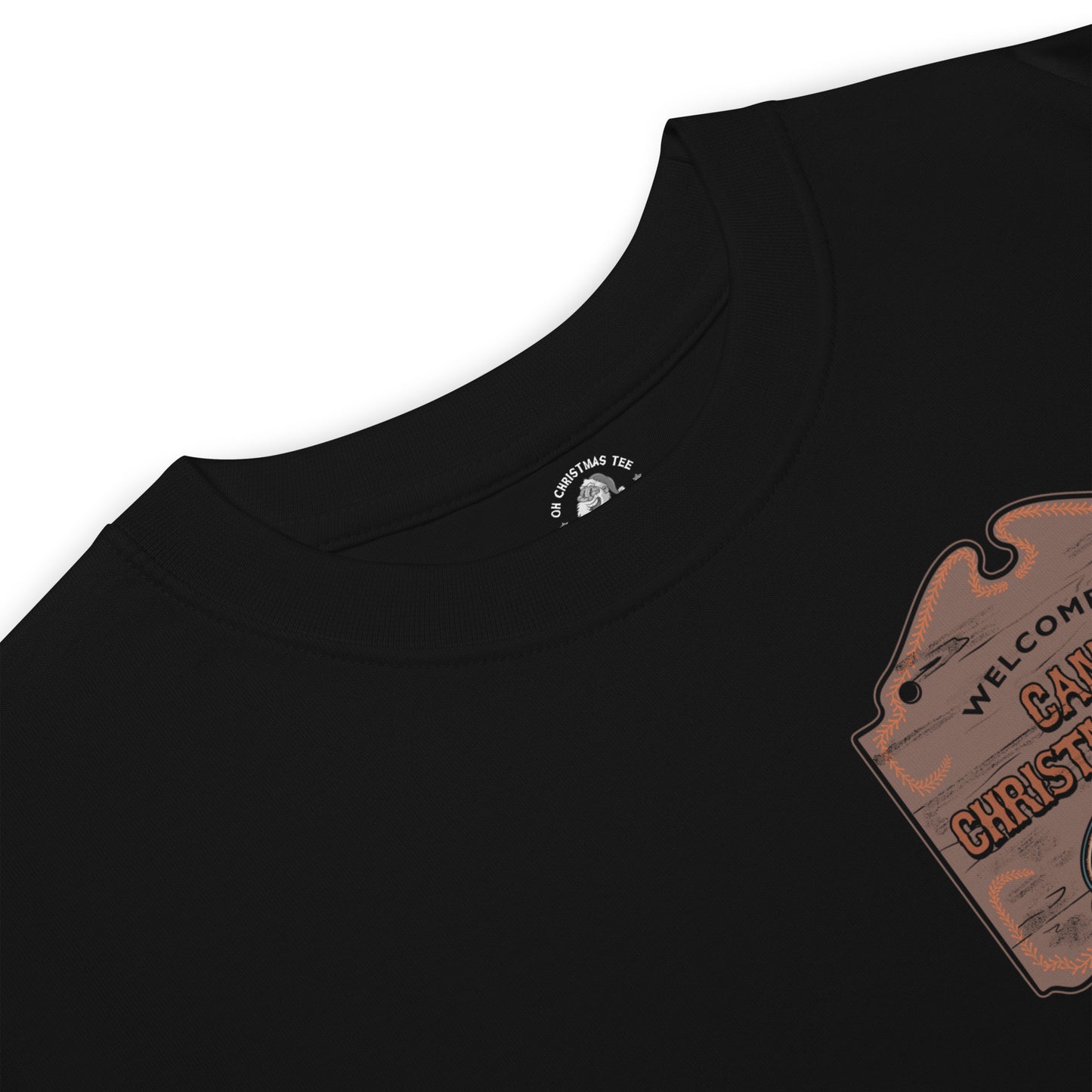 Product mockup featuring a black t-shirt with a wooden sign on the chest that says "Welcome to Camp Christmas Lake"