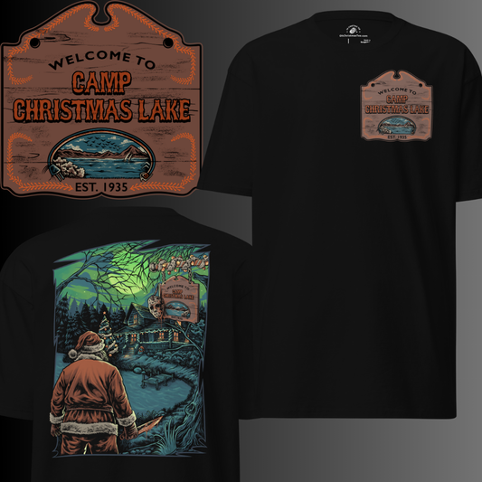 A black t-shirt features a horror-themed Christmas design. Santa Claus is depicted from behind, facing a cabin by a lake under a green full moon. A sign reads "Welcome to Camp Christmas Lake," a clear parody of the Friday the 13th franchise. Santa appears to be in the role of a slasher villain.